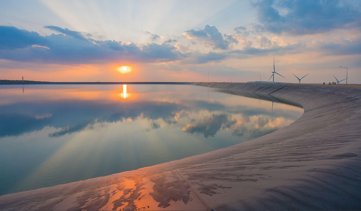 wind turbine generating electricity on dam catchment landscape energy transmission distribution equipment in natural environment